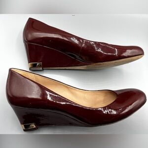 Tory Burch Women's Burgundy Pumps with wedge heels. Gold accents. Size 10.